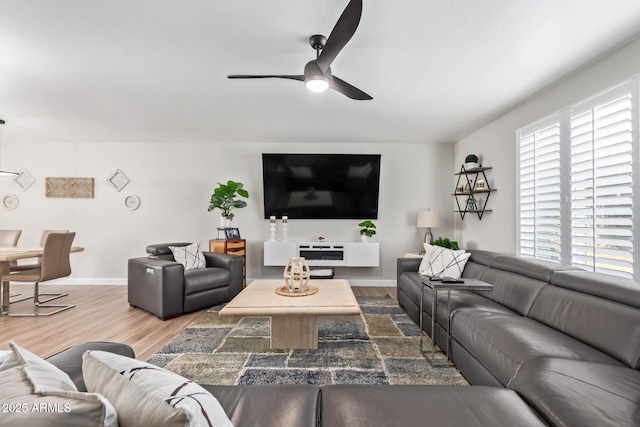 living room featuring wood-type flooring and ceiling fan