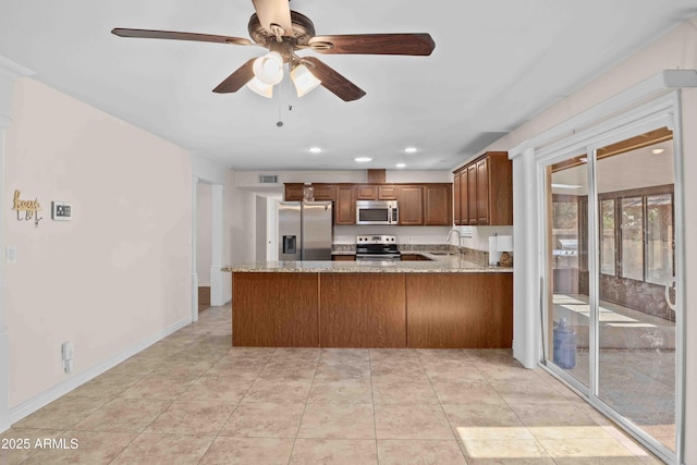 1158 N Barkley St, Mesa, AZ 85203 - kitchen featuring appliances with stainless steel finishes, a ceiling fan, a peninsula, light stone countertops, and recessed lighting