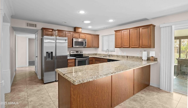 1158 N Barkley St, Mesa, AZ 85203 - kitchen featuring appliances with stainless steel finishes, a peninsula, brown cabinetry, recessed lighting, and light tile patterned floors