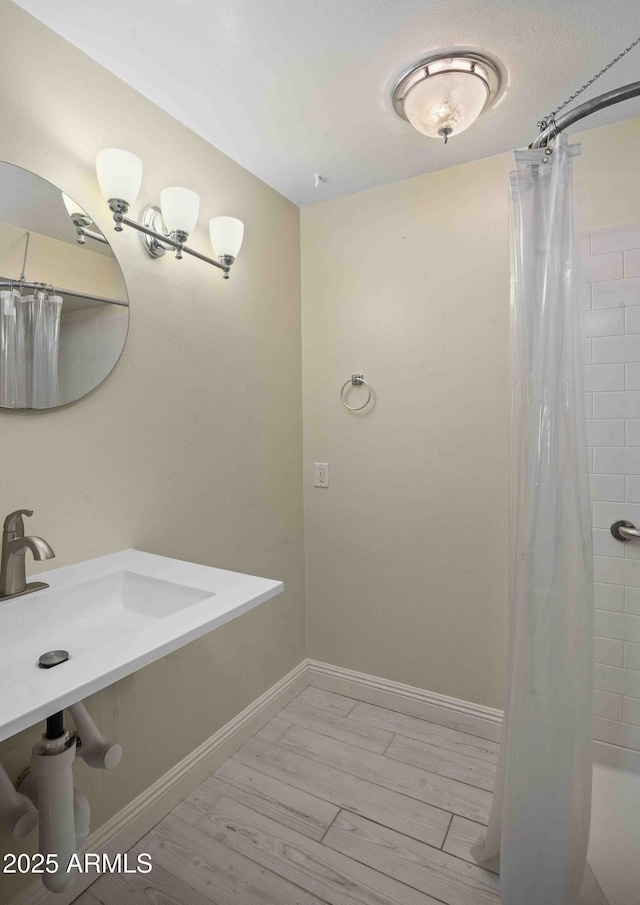 1158 N Barkley St, Mesa, AZ 85203 - full bath with a shower with shower curtain and wood finished floors
