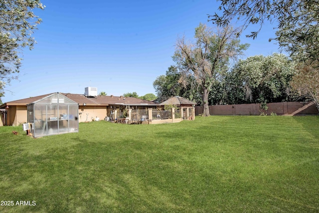 1158 N Barkley St, Mesa, AZ 85203 - fenced backyard with a greenhouse, a gazebo, and an outdoor structure