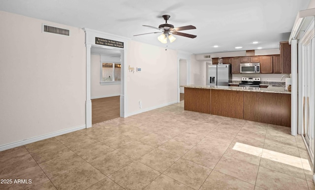 1158 N Barkley St, Mesa, AZ 85203 - kitchen featuring appliances with stainless steel finishes, a ceiling fan, a peninsula, recessed lighting, and light stone countertops