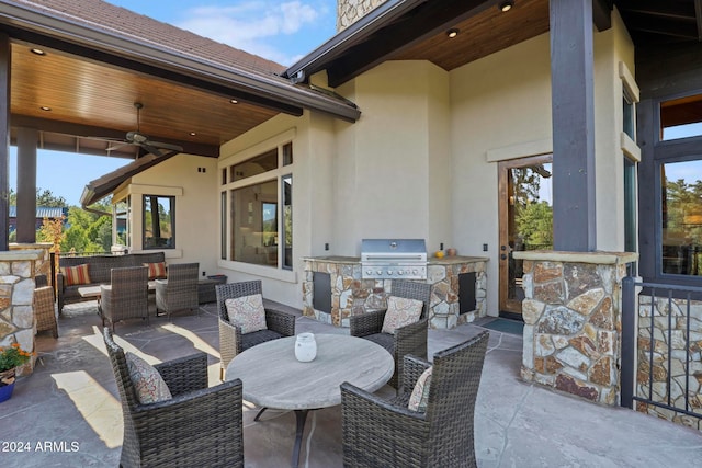 view of patio featuring exterior kitchen, ceiling fan, and area for grilling