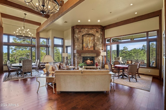 living room featuring beam ceiling, a fireplace, a wealth of natural light, and dark hardwood / wood-style flooring