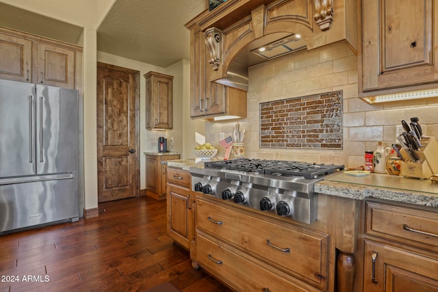 kitchen featuring a textured ceiling, stainless steel appliances, backsplash, and dark hardwood / wood-style flooring