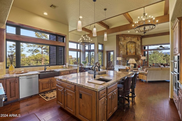 kitchen featuring light stone counters, sink, stainless steel dishwasher, a center island with sink, and dark hardwood / wood-style flooring