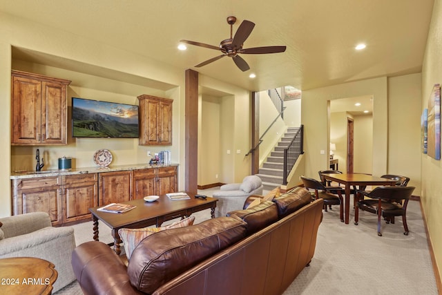 living room featuring ceiling fan and light colored carpet