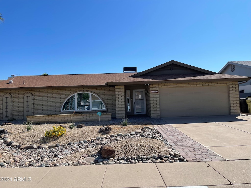 single story home featuring a garage