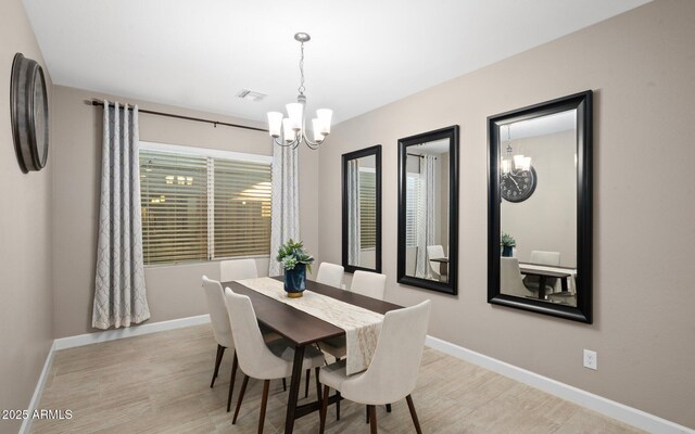 12152 W Briles Rd, Peoria, AZ 85383 - dining room featuring a chandelier, light wood-style floors, and baseboards