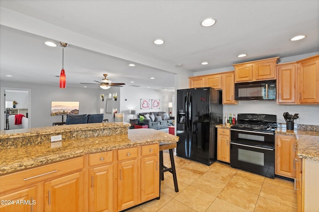 kitchen with light stone countertops, ceiling fan, hanging light fixtures, light tile patterned flooring, and black appliances