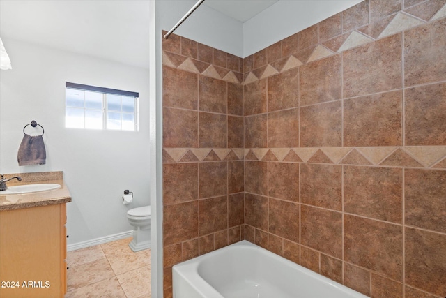 full bathroom with tile patterned flooring, vanity, toilet, and tiled shower / bath