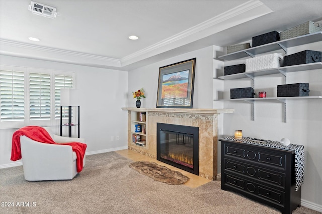 sitting room featuring carpet flooring, a raised ceiling, and crown molding