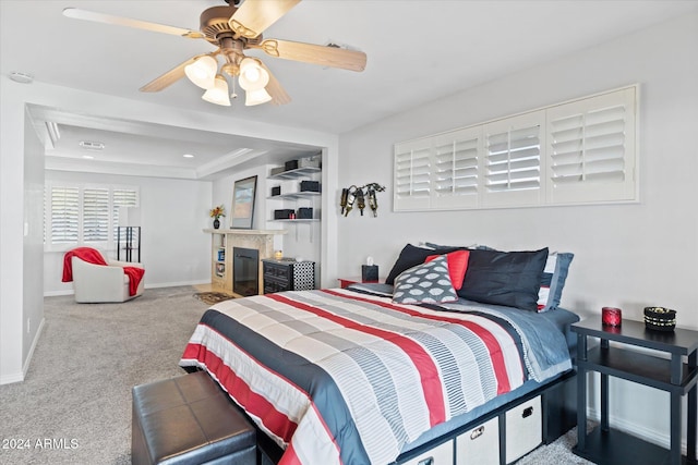 bedroom featuring carpet flooring, a raised ceiling, ceiling fan, and ornamental molding