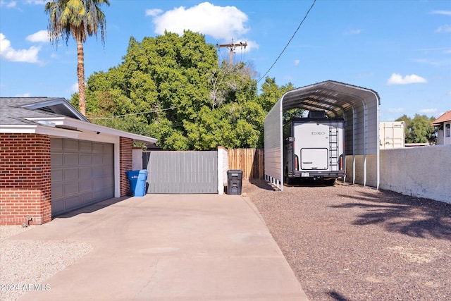 view of side of home featuring a garage and a carport