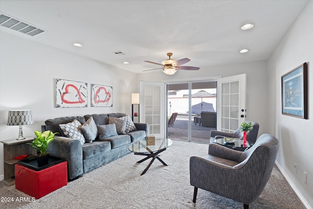 carpeted living room featuring french doors and ceiling fan