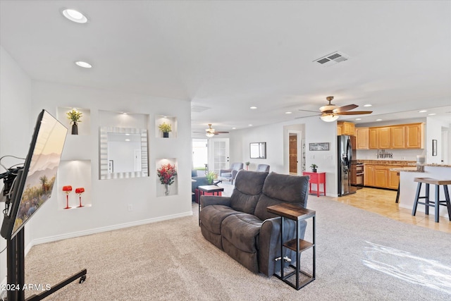 living room with ceiling fan and light carpet