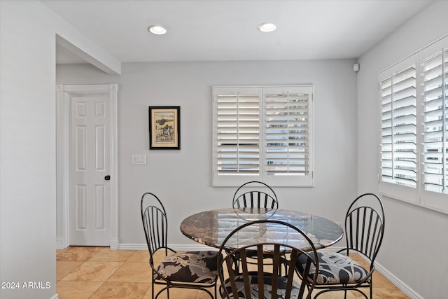 dining area with light tile patterned floors and a healthy amount of sunlight