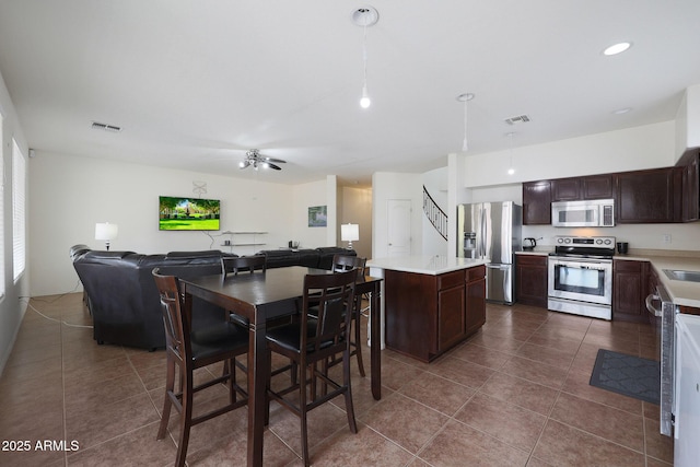 dining area featuring dark tile patterned flooring, visible vents, ceiling fan, and recessed lighting