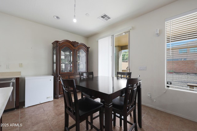 dining space featuring tile patterned flooring, visible vents, and baseboards