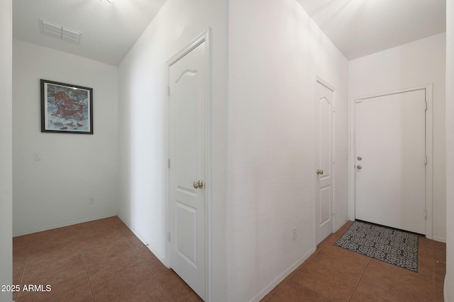 hall featuring visible vents and tile patterned floors