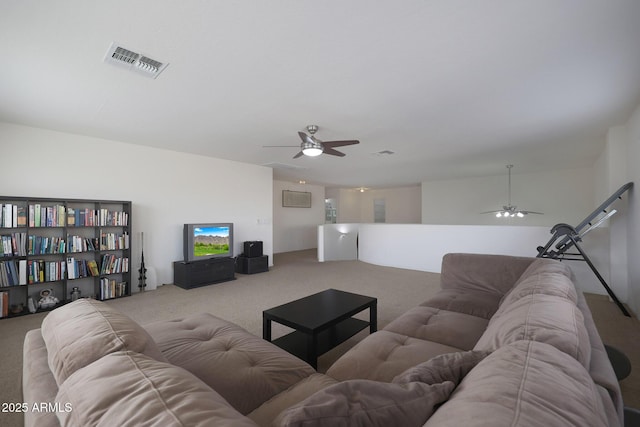 living room with carpet, visible vents, and ceiling fan