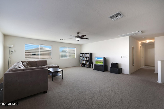 living room with ceiling fan, carpet floors, and visible vents