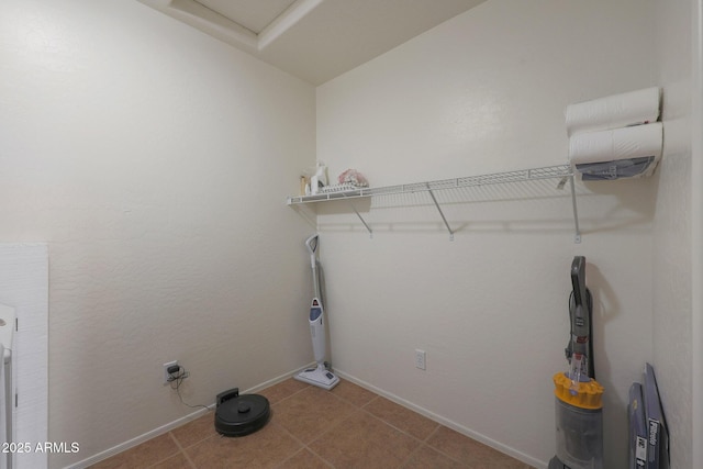 clothes washing area featuring baseboards