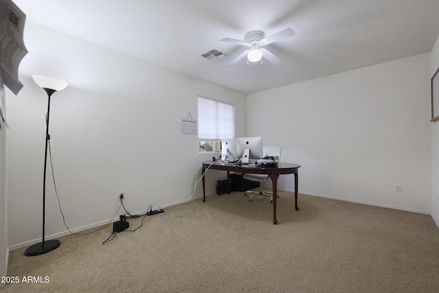 carpeted home office with ceiling fan, visible vents, and baseboards