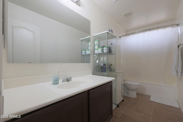 bathroom with toilet, vanity, visible vents, and tile patterned floors