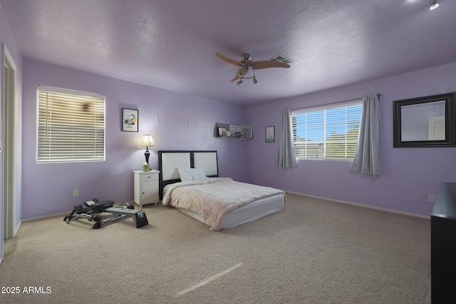 bedroom with baseboards, visible vents, ceiling fan, a textured ceiling, and carpet flooring