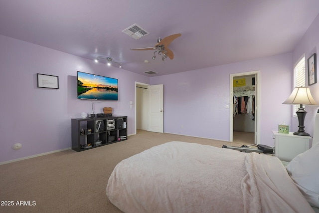 bedroom with carpet floors, visible vents, baseboards, and a ceiling fan