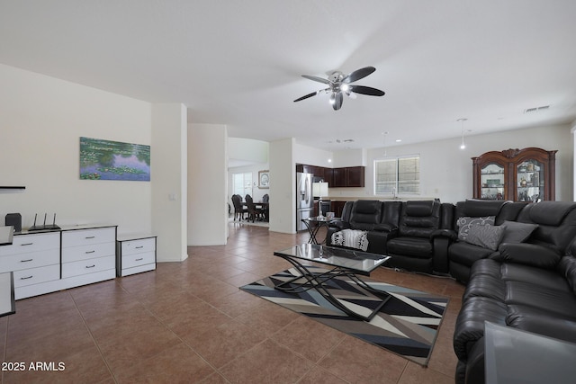 tiled living room with ceiling fan and visible vents