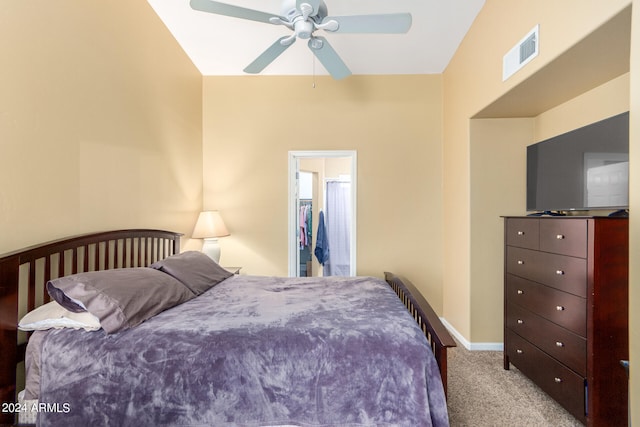 carpeted bedroom with vaulted ceiling and ceiling fan