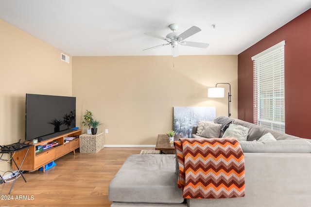 living room with ceiling fan and light hardwood / wood-style flooring