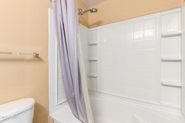 bathroom featuring shower / bath combo and toilet