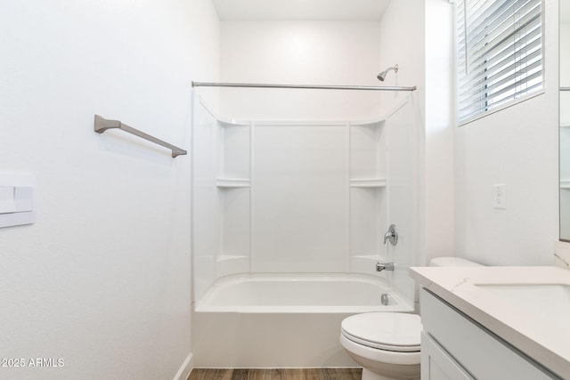 full bathroom with wood-type flooring, vanity, bathing tub / shower combination, and toilet