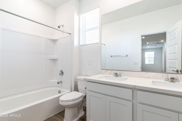 full bathroom with vanity, hardwood / wood-style floors, shower / bathing tub combination, and toilet