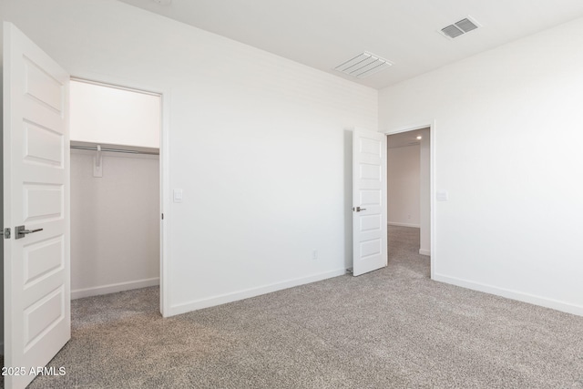 unfurnished bedroom featuring carpet floors and a closet