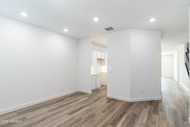 unfurnished room with dark hardwood / wood-style flooring