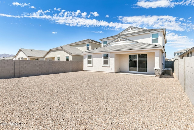 rear view of house with a patio and cooling unit