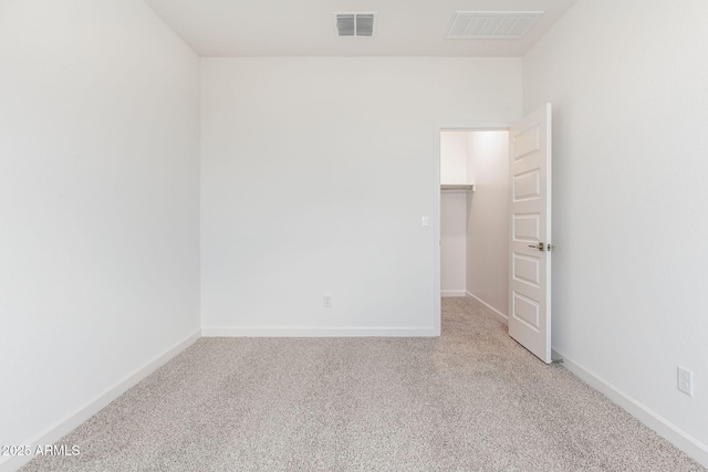 unfurnished room featuring light carpet