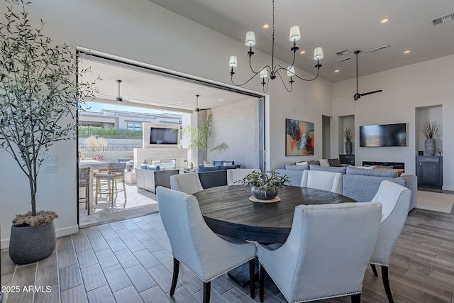 dining room featuring ceiling fan with notable chandelier