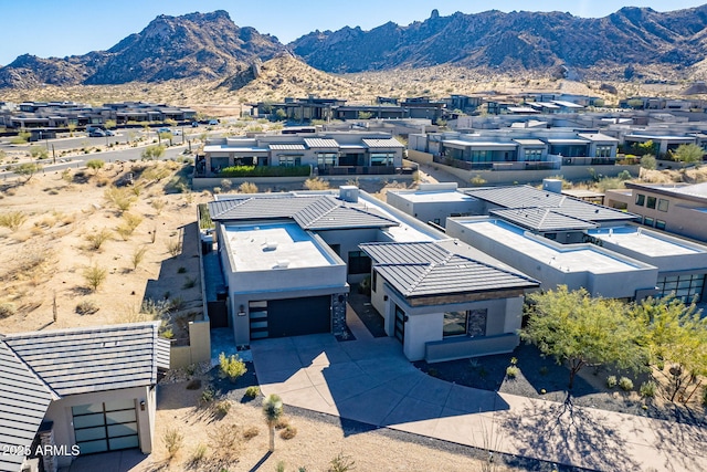 birds eye view of property with a mountain view