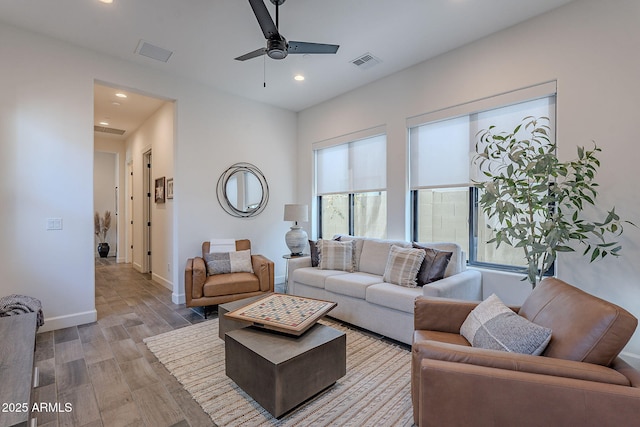 living room with plenty of natural light and ceiling fan