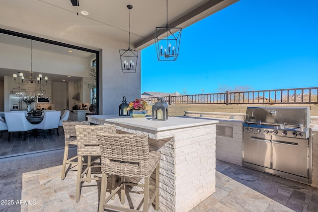 view of patio with an outdoor bar and a grill