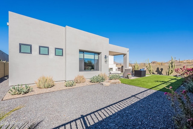 rear view of house featuring an outdoor living space, a patio area, and a yard