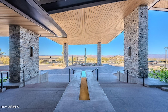 surrounding community featuring a mountain view and a patio