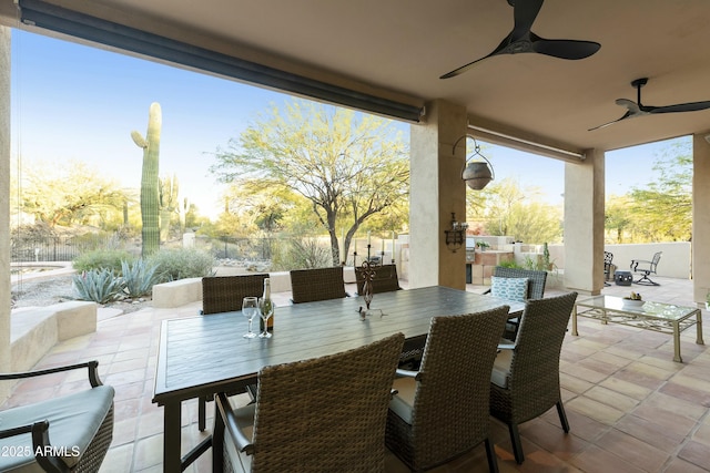 sunroom featuring ceiling fan