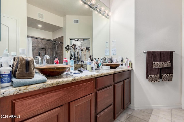 bathroom with tile patterned floors, vanity, and walk in shower