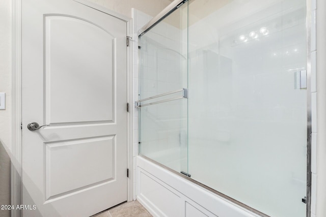 bathroom with tile patterned flooring and enclosed tub / shower combo